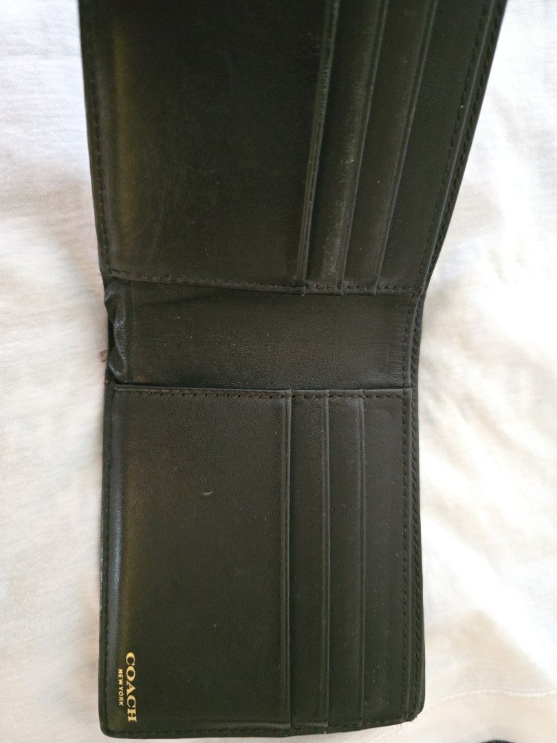 Coach Men's Bi-Fold Wallet (Category: Bags & Wallets) located in Singapore. Submitted by cancerhonda (Listing ID 1377087508, Image 2). Description: - Authentic Coach bi-fold wallet - Features the iconic Coach pattern - Includes multiple card slots - Has a bill compartment - Shows some signs of wear, but in good condition - Perfect for everyday use.