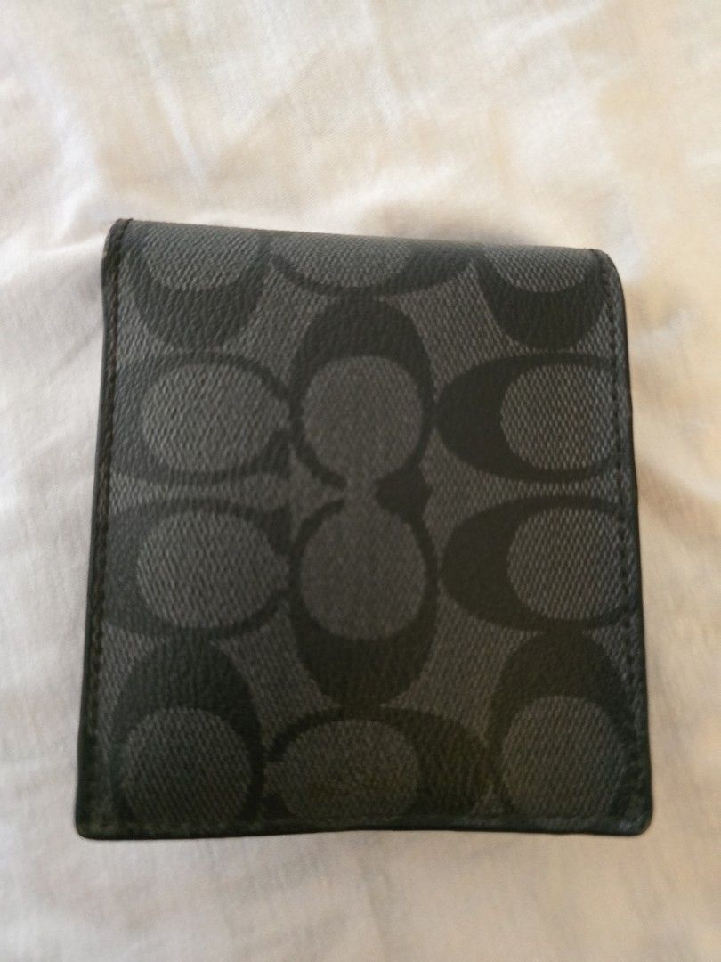 Coach Men's Bi-Fold Wallet (Category: Bags & Wallets) located in Singapore. Submitted by cancerhonda (Listing ID 1377087508, Image 1). Description: - Authentic Coach bi-fold wallet - Features the iconic Coach pattern - Includes multiple card slots - Has a bill compartment - Shows some signs of wear, but in good condition - Perfect for everyday use.
