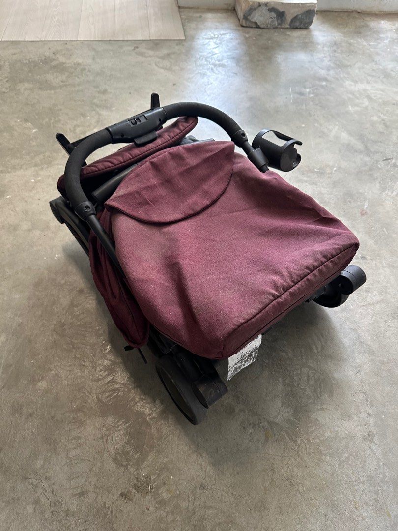 Compact Stroller - Maroon (Category: Strollers) located in Singapore. Submitted by Vivi27 (Listing ID 1377163478, Image 2). Description: Compact and easy to fold stroller in good condition. Features a sunshade and cup holder. Perfect for travel and everyday use. Shows some signs of wear, but fully functional. See photos for details..