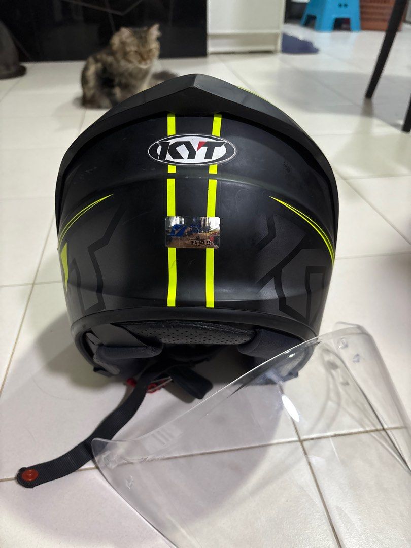 KYT Motorcycle Helmet with Rainbow Visor (Category: Motorcycle Apparel) located in Singapore. Submitted by iajdndjskakos (Listing ID 1377131039, Image 1). Description: Selling this KYT motorcycle helmet. It has a cool iridescent visor that changes colors. The helmet is black with neon yellow accents. It looks like it has been used a few times, but it's still in good condition. The visor is in great shape, and the helmet has a secure strap. It's a