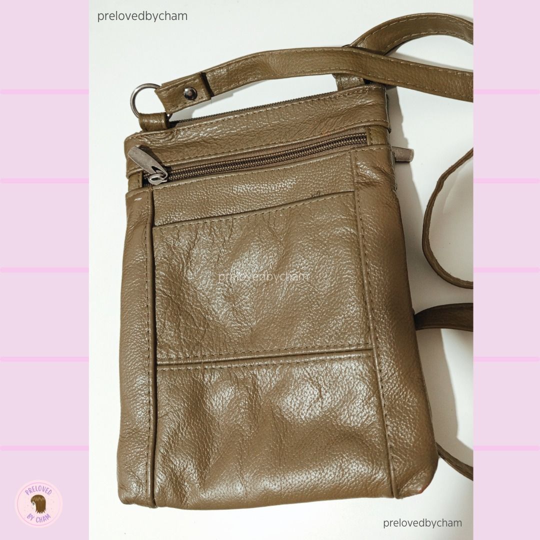 Olive color Crossbody Bag (Category: Cross-body Bags) located in Calamba. Submitted by prelovedbycham (Listing ID 1377138958, Image 1). Description: - still in good condition - faux leather - with zippers (see pic) Strap: 32" Bag Size: 6.5"X 8.5" *Shipping Fee is shouldered by the buyer WILL NOT ENTERTAIN: -People who haggle too much (note that price is fixed) and ask for too much personal info. Only SURE buyers, please! -Individuals with dummy a