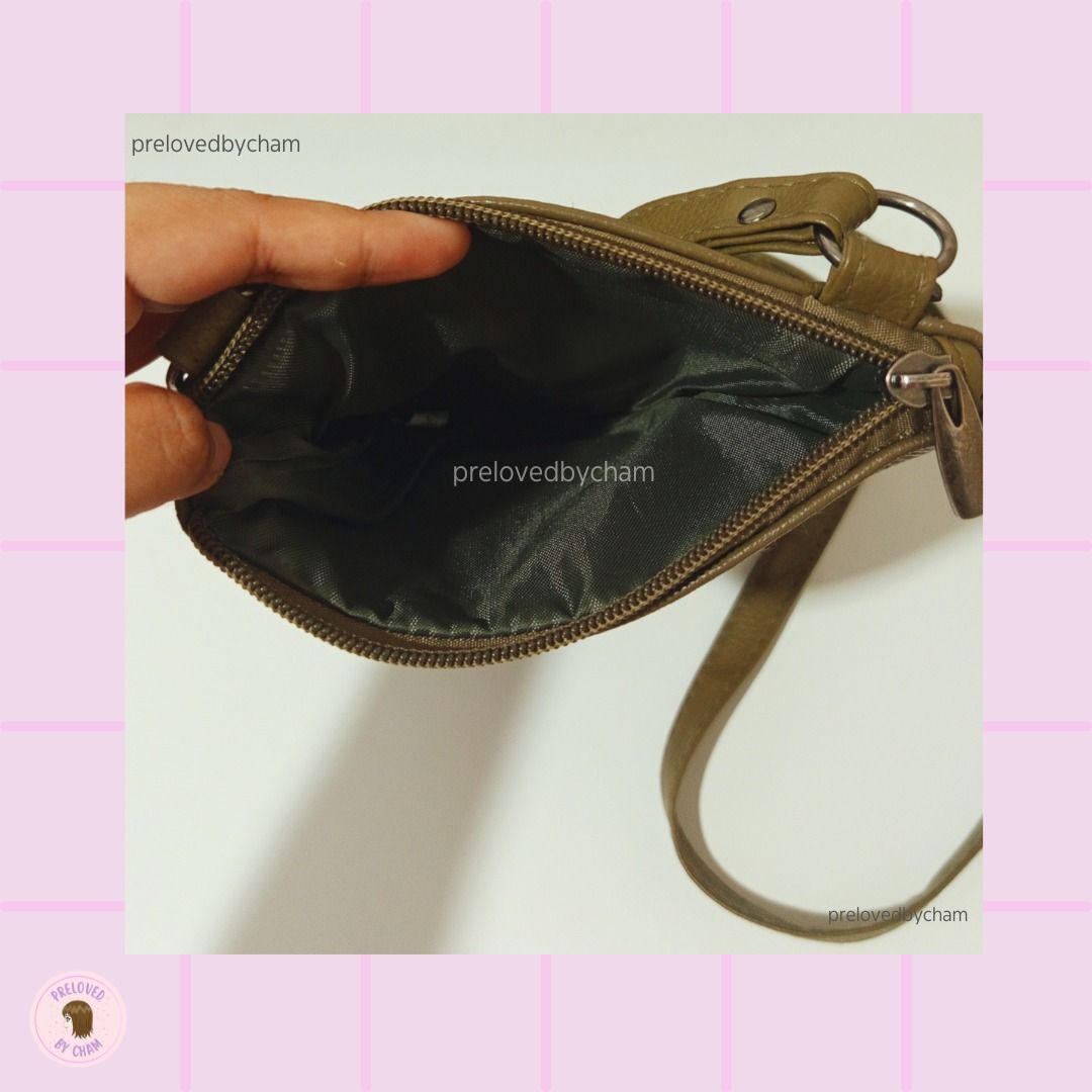 Olive color Crossbody Bag (Category: Cross-body Bags) located in Calamba. Submitted by prelovedbycham (Listing ID 1377138958, Image 2). Description: - still in good condition - faux leather - with zippers (see pic) Strap: 32" Bag Size: 6.5"X 8.5" *Shipping Fee is shouldered by the buyer WILL NOT ENTERTAIN: -People who haggle too much (note that price is fixed) and ask for too much personal info. Only SURE buyers, please! -Individuals with dummy a