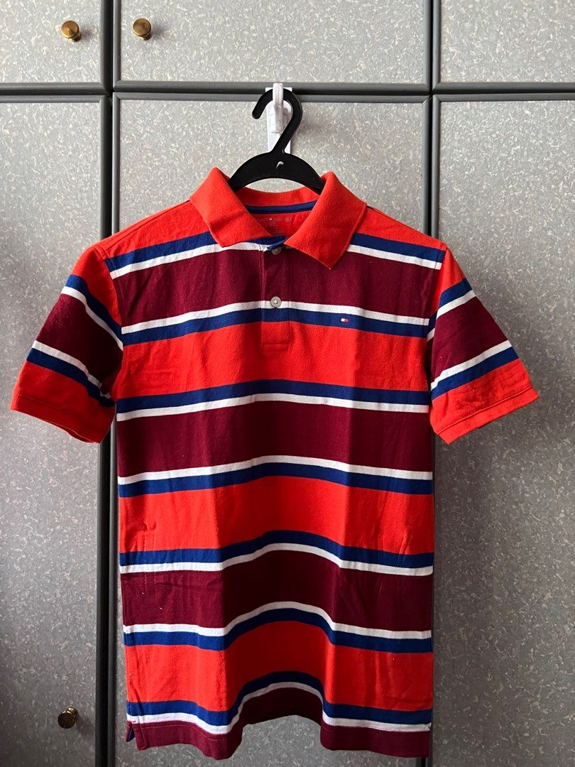 Tommy Hilfiger Striped Polo Shirt - Size L (Category: Babies & Kids Fashion) located in Singapore. Submitted by lsldion (Listing ID 1377040075, Image 1). Description: - Tommy Hilfiger polo shirt (kids) - Stripped design - Size L (12-14) - Classic polo collar and short sleeves - Never worn before, only washed once - Perfect for casual wear and for new born gifts.