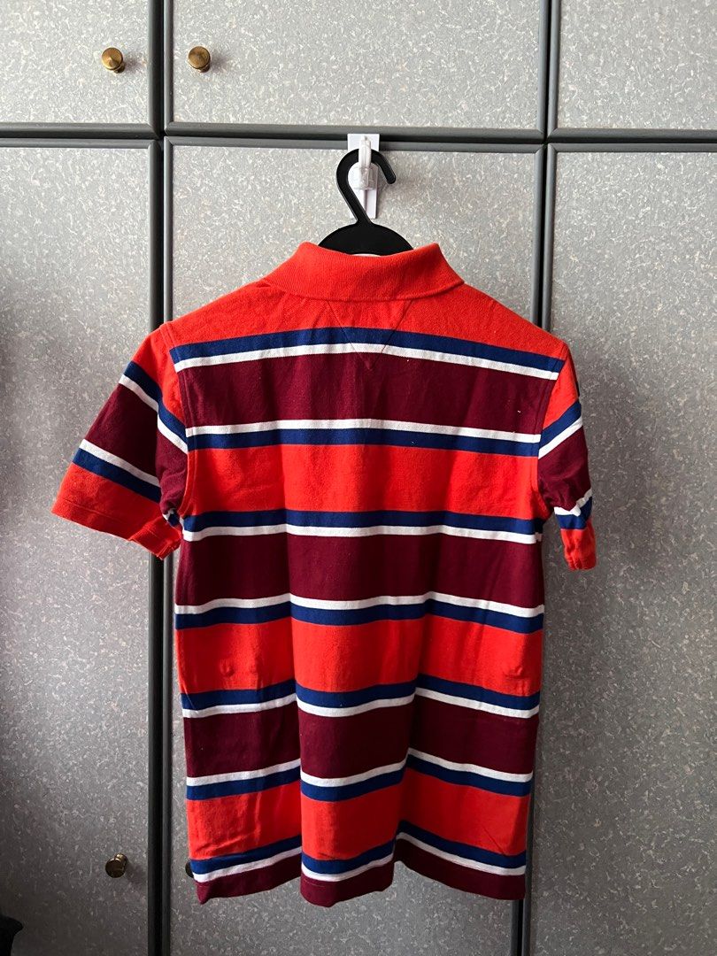 Tommy Hilfiger Striped Polo Shirt - Size L (Category: Babies & Kids Fashion) located in Singapore. Submitted by lsldion (Listing ID 1377040075, Image 2). Description: - Tommy Hilfiger polo shirt (kids) - Stripped design - Size L (12-14) - Classic polo collar and short sleeves - Never worn before, only washed once - Perfect for casual wear and for new born gifts.