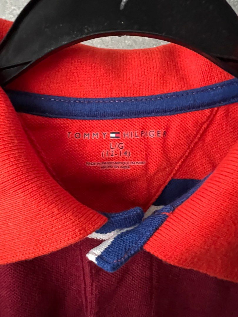Tommy Hilfiger Striped Polo Shirt - Size L (Category: Babies & Kids Fashion) located in Singapore. Submitted by lsldion (Listing ID 1377040075, Image 3). Description: - Tommy Hilfiger polo shirt (kids) - Stripped design - Size L (12-14) - Classic polo collar and short sleeves - Never worn before, only washed once - Perfect for casual wear and for new born gifts.