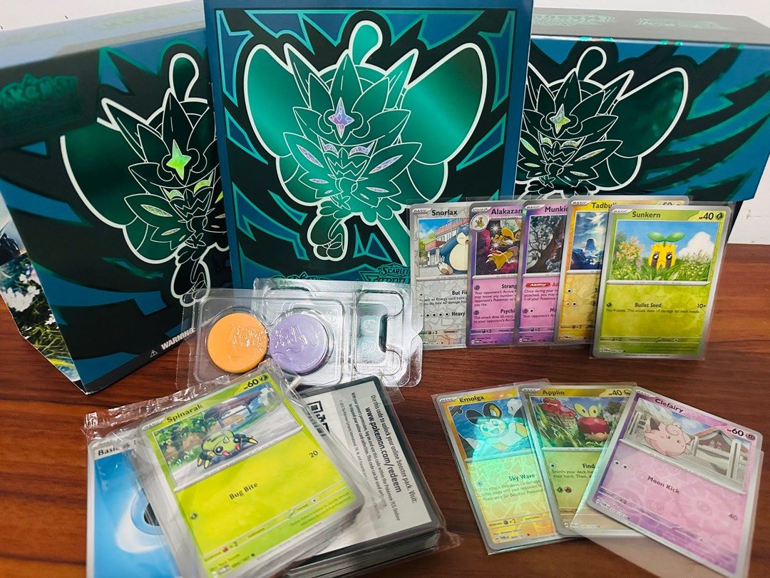 Twilight Masquerade (Category: Raw Singles) located in Balanga. Submitted by kitkat1021 (Listing ID 1377074907, Image 1). Description: Twilight Masquerade ETB - Box with flaw on the edges - Accessories - Manual -Dice -Coin -40pcs Energy Cards -50 pcs (common uncommon cards) -50pcs code cards (From OBF TWM JTG) with -snorlax reverse holo -alakazam holo -munkidori holo -Tadbulb reverse holo -Sunkern reverse holo -Emolga/applin/clefairy reverse holo