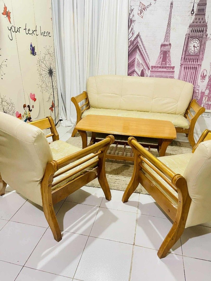 A Wooden Couch Sofa Set (Category: Sofas) located in Valenzuela. Submitted by jenelyn6 (Listing ID 1377324886, Image 1). Description: Sale❗❗❗ A Wooden Couch Sofa Set in German Leather pads, 3-1-1 Seater with Center Table. In very gppd condition. Solid teakwood made. Details: 3seater: L:68 xW:28 xH:32inches Solo seater: W:31 xDepth:28 xH:32inches Center Table: L:41 xW:23 xH:18inches 25k php ➕ delivery charge fee.