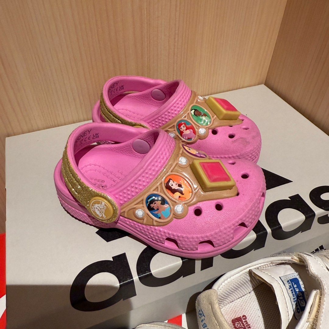 Crocs Disney Princess Clogs - Size C5 (Category: Babies & Kids Fashion) located in Singapore. Submitted by robinsparkless (Listing ID 1377316901, Image 1). Description: Authentic Crocs clogs featuring a Disney Princess theme. Size C5. Pink in color. Lightly used, with some wear on the soles. Includes the original Disney Princess jibbitz. Perfect for any little princess!.