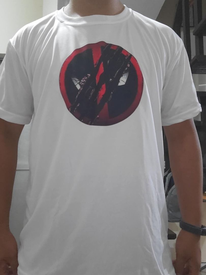 Deadpool & Wolverine Logo White Drifit Shirt (Category: Activewear) located in Manila. Submitted by mwnadala (Listing ID 1367669331, Image 2). Description: Color: White Size: Large, 2XL, 3XL Make:Dri-Fit Condition: New Reason for Selling: n/a Meet Up Location: Kalentong or LRT 2 V. Mapa Station Issues: None.