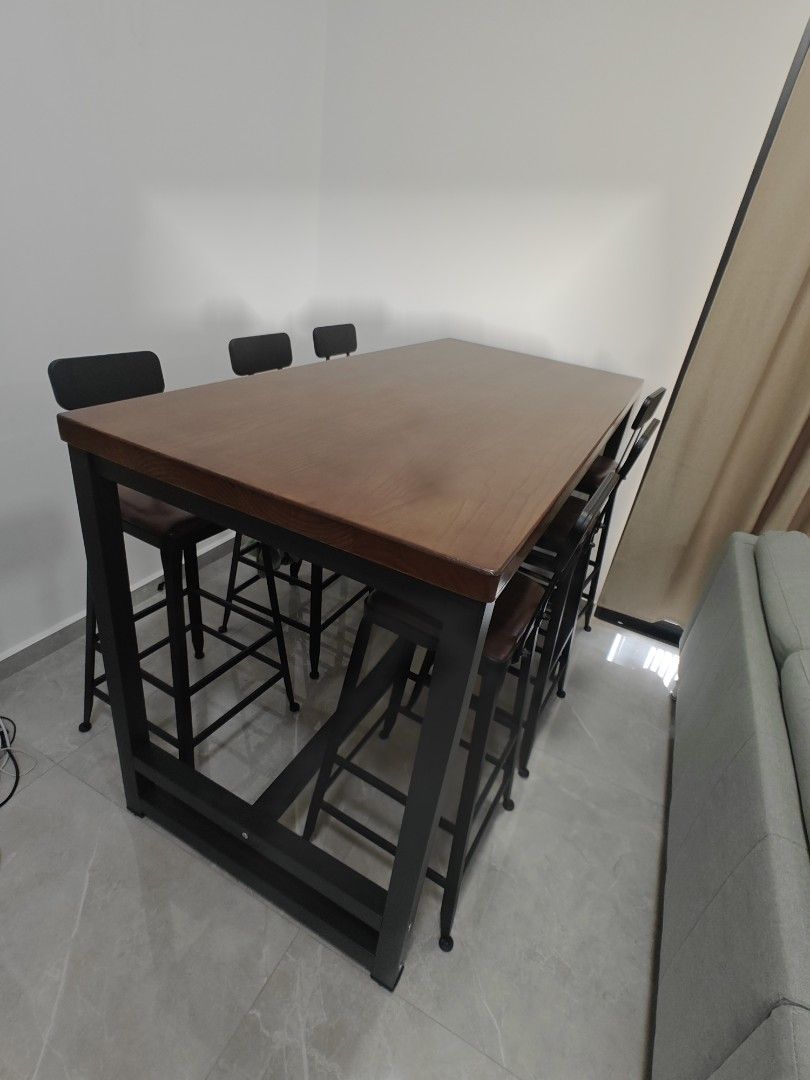 Table with Stools (Category: Tables & Sets) located in Singapore. Submitted by 266jt (Listing ID 1377224580, Image 2). Description: - brought 2 sets and too big for my house. as good as new - each consist of 1 table and 6 tall stools - Stylish bar table set - Sturdy black metal frame - Warm wooden tabletop - Matching bar stools with comfortable brown seats - Dimensions: 1.7m (L) x 0.8m (W) x 1.4m (H).