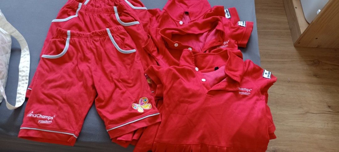 Mindchamps Uniform Set - Red (Category: Babies & Kids Fashion) located in Singapore. Submitted by suga0393 (Listing ID 1377245807, Image 3). Description: - Mindchamps uniform set - Red color - Includes shorts and polo shirts - Shorts feature pockets with grey trim - Polo shirts have Mindchamps logo on the sleeve - Suitable for school wear.