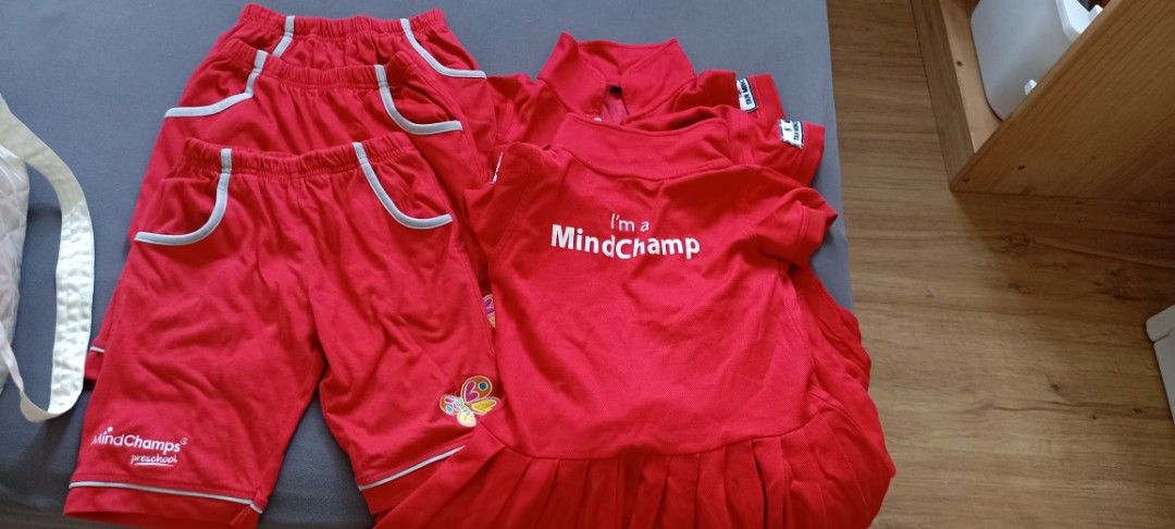 Mindchamps Uniform Set - Red (Category: Babies & Kids Fashion) located in Singapore. Submitted by suga0393 (Listing ID 1377245807, Image 1). Description: - Mindchamps uniform set - Red color - Includes shorts and polo shirts - Shorts feature pockets with grey trim - Polo shirts have Mindchamps logo on the sleeve - Suitable for school wear.