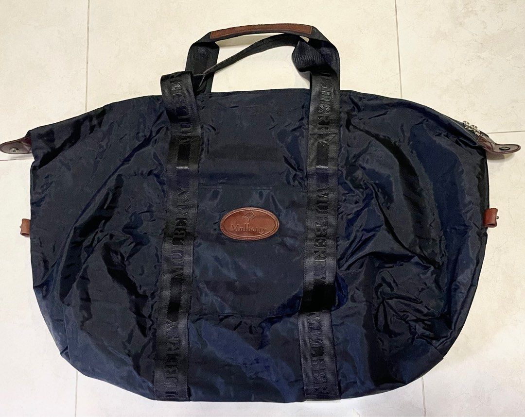 Mulberry Vintage XL Travel Duffle Bag - Black (Category: Bags & Wallets) located in Singapore. Submitted by clamtypes (Listing ID 1377299418, Image 1). Description: Size: 69cm x47cm when unfolded Travel bag that folds into a 35x27cm zippered pouch. Features a spacious interior and a separate pouch. Includes leather accents and the iconic Mulberry logo. Selling for cheap due to musky smell. Washed by professional bag cleaners already Smartpac deli