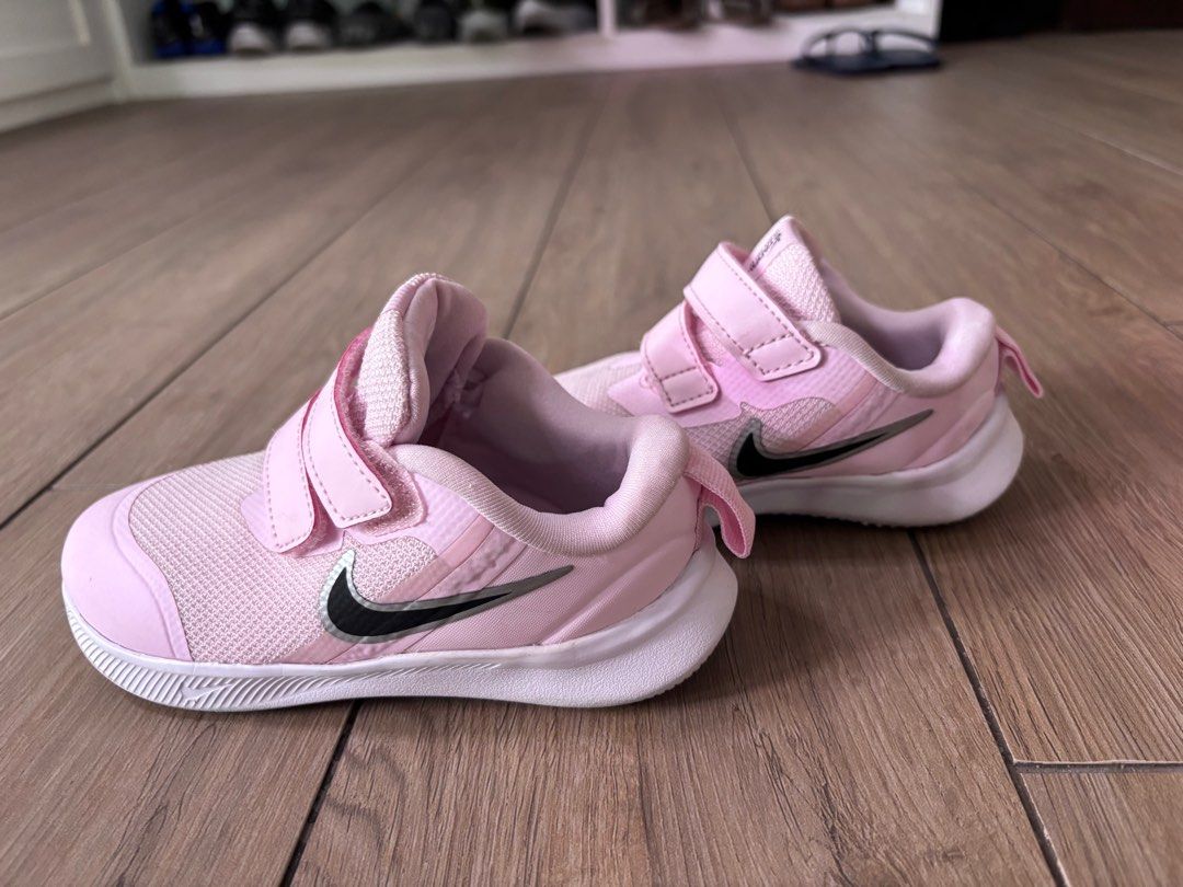 Nike Star Runner 3 Toddler Shoes - Pink (Category: Babies & Kids Fashion) located in Singapore. Submitted by kezshop (Listing ID 1377287455, Image 3). Description: Size: UK 7.5 EU: 25 These Nike Star Runner 3 toddler shoes are in good condition. They feature a pink mesh upper with black Nike swoosh logos. The shoes have velcro straps for easy on and off. The soles show some wear, but the shoes are still in great shape..