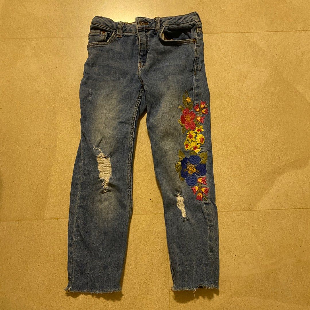 5-6yo Zara Girls Floral Embroidered Jeans (Category: Babies & Kids Fashion) located in Singapore. Submitted by momofgirls (Listing ID 1377508353, Image 1). Description: These Zara jeans feature beautiful floral embroidery and distressed details. They have an adjustable waistband for a comfortable fit. The jeans are in good condition with some signs of wear. Perfect for adding a touch of style to your little one's wardrobe. Fits 5yo.