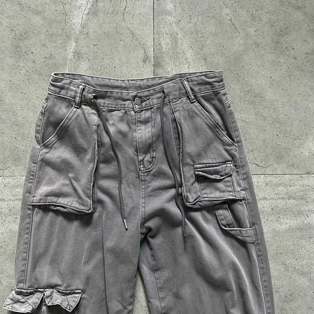 Faded Grey Wide Flared Utility Cargo Pants (Category: Jeans) located in Pasig City. Submitted by deteriortdmaterial (Listing ID 1377509621, Image 2). Description: Faded Grey Wide Flared Utility Cargo Pants Features a drawstring in the waist band Waist: 32 inches Rise: 12.5 inches Inseam: 28 inches Length: 41 inches Hem: 11 inches Price: 1750 + sf DM TO PURCHASE.
