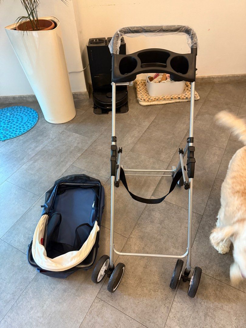 Foldable Pet Stroller. (Category: Homes & Other Pet Accessories) located in Singapore. Submitted by sxxxseansxxx (Listing ID 1377442507, Image 1). Description: This pet stroller is in excellent condition. It features a navy blue and cream canopy, a cup holder, and a storage basket. The stroller is easy to fold and unfold. Perfect for taking your furry friend on walks!.