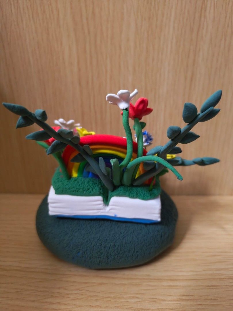 Handmade Super Light Clay Figurine - Rainbow Garden (Category: Toys & Games) located in Singapore. Submitted by heiery (Listing ID 1377560332, Image 3). Description: - Handmade clay figurine - Features a rainbow, flowers, and a bunny holding a heart - Adds a touch of whimsy to your desk or shelf - Vibrant colors and intricate details.