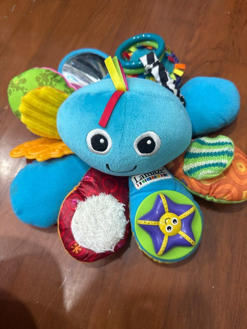 Lamaze Octotunes Baby Toy (Category: Infant Playtime) located in Singapore. Submitted by laruru (Listing ID 1377440847, Image 1). Description: Adorable Lamaze Octotunes baby toy. Features various textures, colors, and sounds to stimulate your baby's senses. Includes a mirror, crinkly fabrics, and a starfish with a smiling face. Perfect for playtime and sensory development..