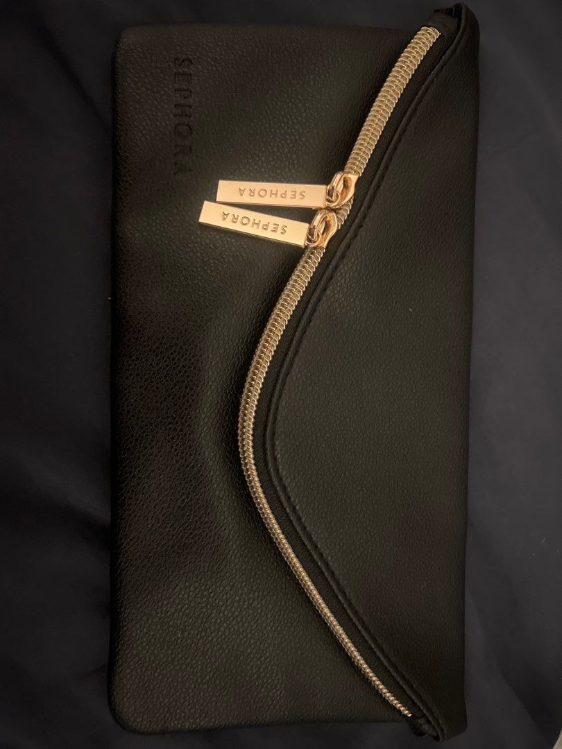 Sephora Black Cosmetic Bag (Category: Purses & Pouches) located in Singapore. Submitted by shrutim (Listing ID 1377540268, Image 2). Description: Brand new Sephora cosmetic bag. Features a black exterior with a gold zipper and two gold Sephora tags. Perfect for storing makeup or other small items. Comes in original packaging..
