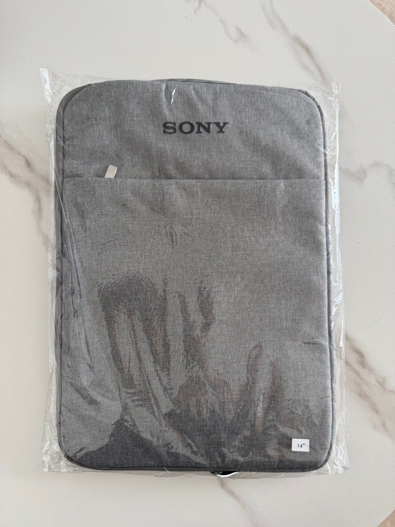 Sony 14" Laptop Sleeve - Brand New (Category: Laptop Bags & Sleeves) located in Singapore. Submitted by puttpp1 (Listing ID 1377386743, Image 1). Description: Brand new Sony laptop sleeve, still in its original packaging. Features a front pocket for accessories. Designed to fit 14-inch laptops. Protect your device in style with this sleek and durable sleeve..