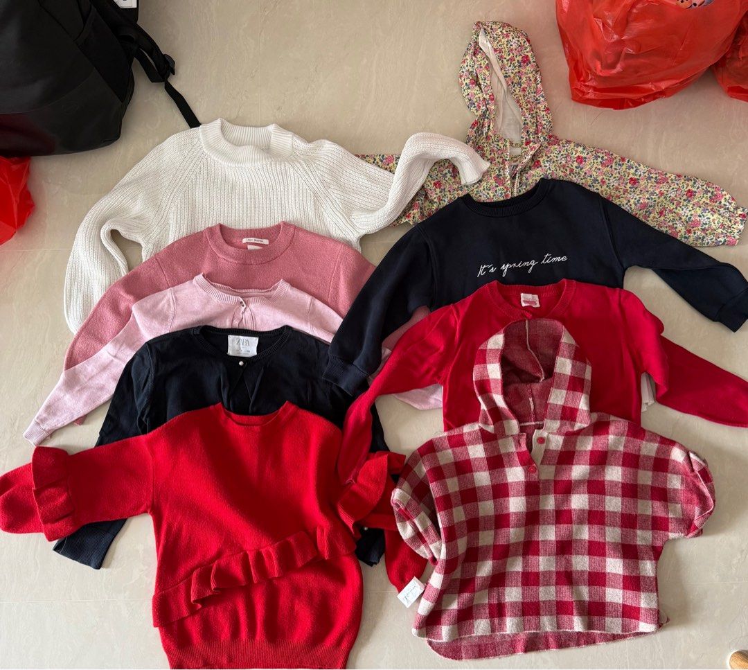 Zara Kids Sweater - Various Sizes (Category: Babies & Kids Fashion) located in Singapore. Submitted by gkl00 (Listing ID 1377399454, Image 1). Description: Bundle of Zara kids sweaters in various colours and styles. Includes a white ribbed sweater, pink sweaters, a black cardigan, a red sweater with ruffles, a red and white checkered hoodie, and a navy sweater with 'It's spring time' text. Great for layering! •Price for 1. •Open to reasonable neg