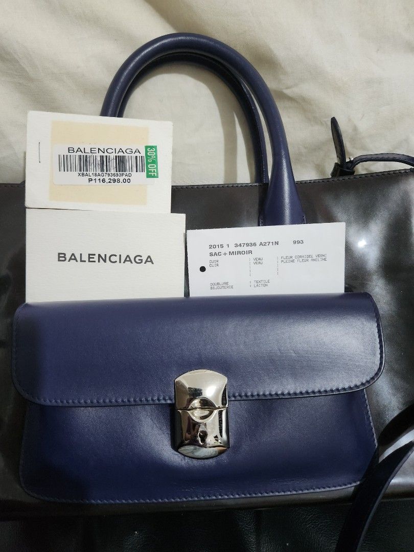 Authentic Balenciaga PADLO,WORK XS AJ (Category: Luxury Bags & Wallets) located in Quezon City. Submitted by ki_cai (Listing ID 1377607976, Image 2). Description: Brand : Balenciaga Condition : excellent, 9.5/10 good as new, just kept in the closet Fabrics : Leather, plastic Colors : Black, Violet with dustbag and tags *dust bag hasn't been washed; yellowish stain from being in the closet for years No meet ups please Buyer will pay for shipping/p