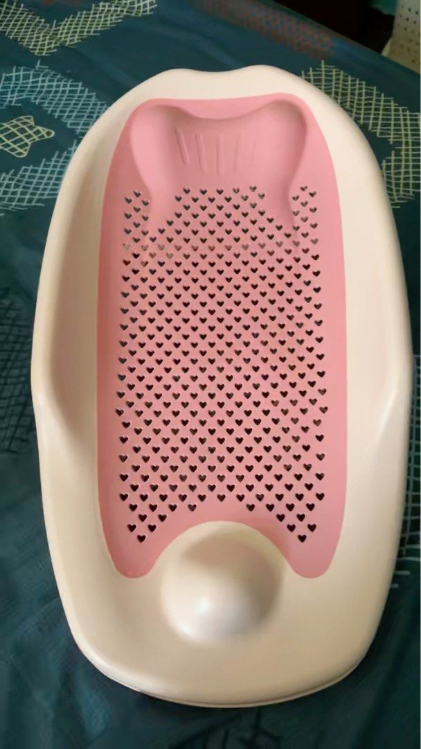 Baby Bath Support - Pink and White (Category: Bathtub & Bath Accessories) located in Singapore. Submitted by mrs_j_mc (Listing ID 1377606809, Image 1). Description: This baby bath support is in like-new condition. It's a lovely pink and white color, perfect for your little one. The design features a heart-shaped pattern, making bath time fun and safe. It's a great way to support your baby during bath time. I'm not sure of the brand, but it's in e