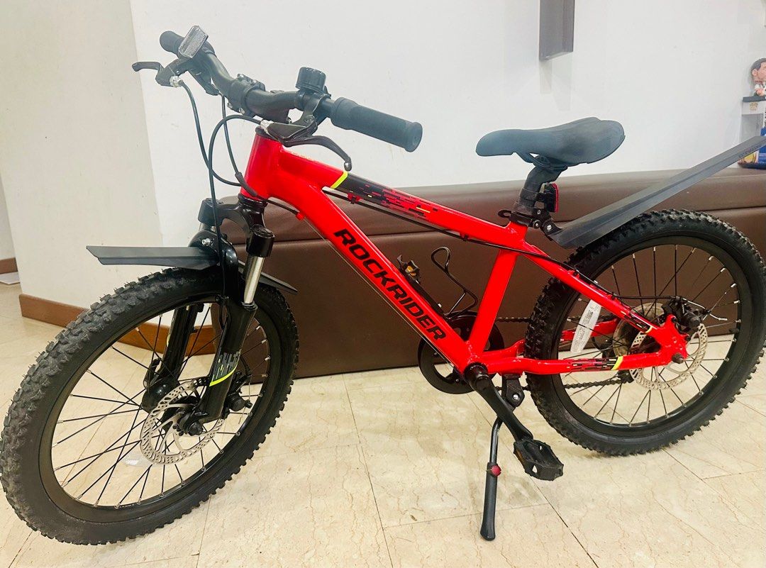 Bicycle (Category: Bicycles) located in Singapore. Submitted by nijardeen (Listing ID 1377679728, Image 2). Description: Decathlon: ST 900 RR 20_QUOTE_ RED CN FR Model has gears and suspension Suitable for primary students age group Rarely used, looks brand new. Accessories: Bike stand Mudguard Cup holder Bell.