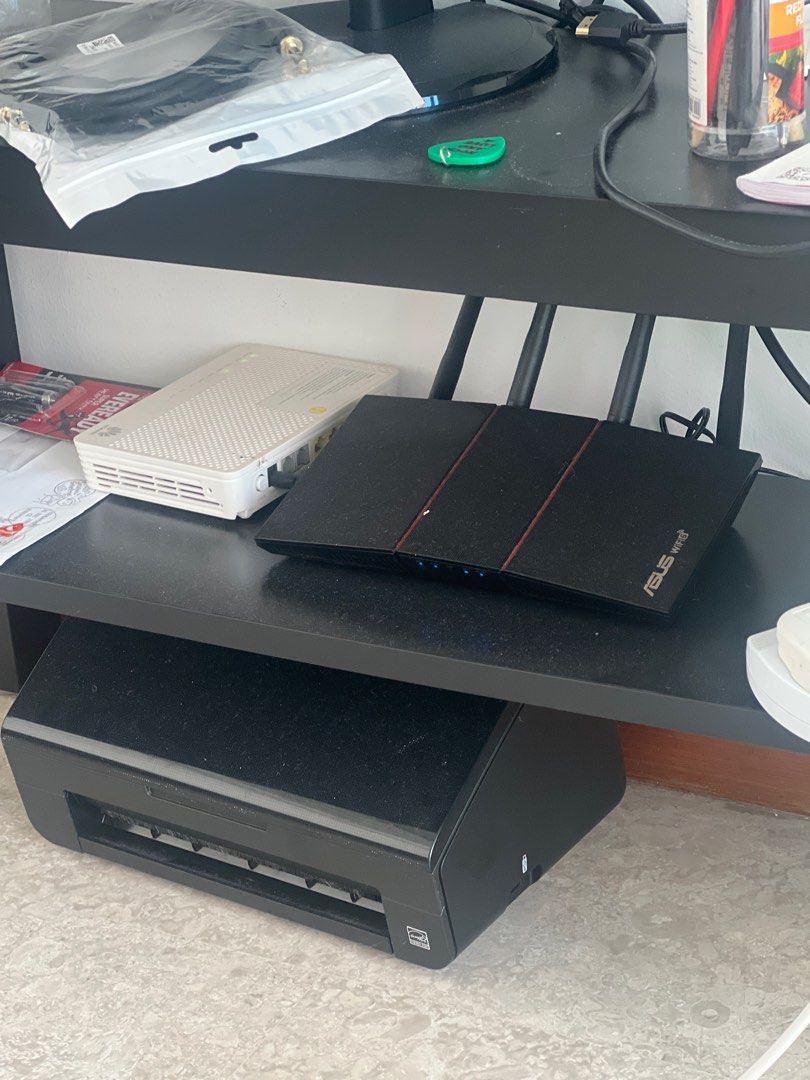 Router (Category: Networking) located in Singapore. Submitted by alaukikn.pant-73900 (Listing ID 1377636081, Image 1). Description: Black Canon printer. Appears to be in good condition. Perfect for home or office use. Please note that the exact model is not visible in the images..