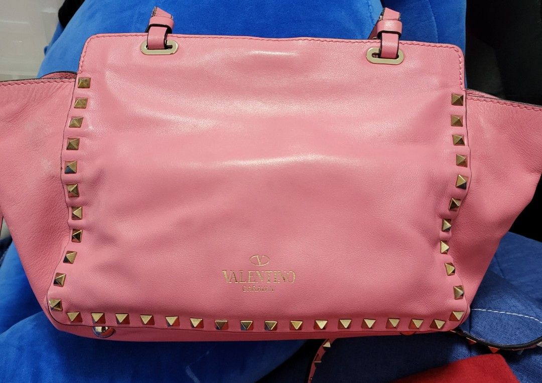 Valentino Rockstud Small Tote Bag - Pink (Category: Bags & Wallets) located in Singapore. Submitted by yvo2405 (Listing ID 1377741354, Image 2). Description: - Authentic Valentino Rockstud Small Tote Bag - Stunning pink color in soft buttery leather n gold hardware - Signature stud detailing with 4 metal feet (studs) at base - Can carry over shoulder or cross body - Includes dust bag and authenticity card - Interior zipped pocket for secure stora