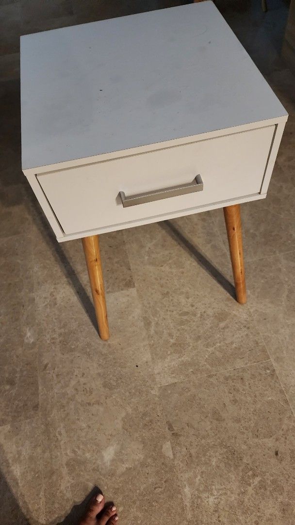 Bedside Table (Category: Shelves, Cabinets & Racks) located in Singapore. Submitted by treasured_gems (Listing ID 1372744906, Image 2). Description: Bedside table in white. Some marking on top but not noticeable once you place items on top. Price reflects - not for fussy buyers. Good for general guest room or a little side project! Pick up Newton.