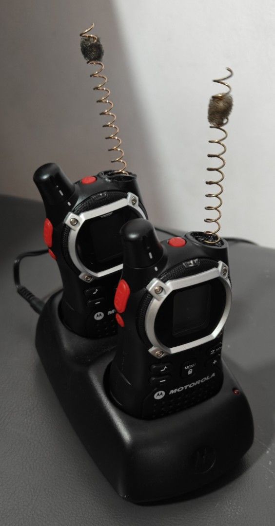 Motorola EM1000R two-way radios (Category: Walkie-Talkie) located in Singapore. Submitted by michelinvvr (Listing ID 1372811888, Image 2). Description: Key features of the Motorola EM1000R include: 22 Channels: for communication. Hands-free operation: with voice-activated transmission. LED flashlight: for emergencies. Mini-USB charging port: for convenient charging. The radios operate using a transmitter and receiver, with an antenna to send and 