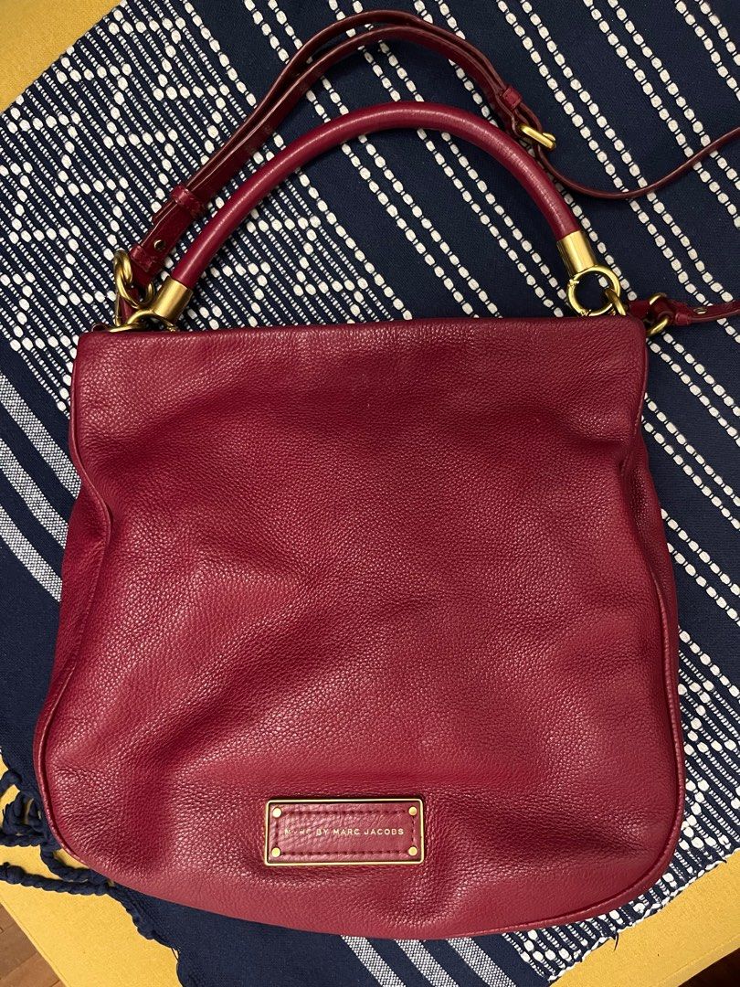 Red Pebbled Leather Crossbody Hobo Shoulder Bag Marc by Marc Jacob (Category: Bags & Wallets) located in Singapore. Submitted by suscir (Listing ID 1372688906, Image 1). Description: Red is not as bright as pictures, the closer colour is picture 3 (handles) Logo faded, on front of bag. Inside lining needs cleaning, reasonable to use if you don’t put anything light colour. Just cleaned with leather gel. Very nice leather. Bag has been well-loved, 