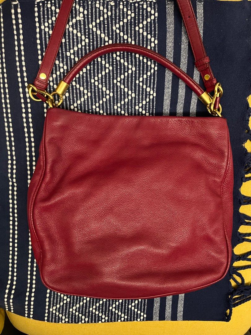 Red Pebbled Leather Crossbody Hobo Shoulder Bag Marc by Marc Jacob (Category: Bags & Wallets) located in Singapore. Submitted by suscir (Listing ID 1372688906, Image 2). Description: Red is not as bright as pictures, the closer colour is picture 3 (handles) Logo faded, on front of bag. Inside lining needs cleaning, reasonable to use if you don’t put anything light colour. Just cleaned with leather gel. Very nice leather. Bag has been well-loved, 