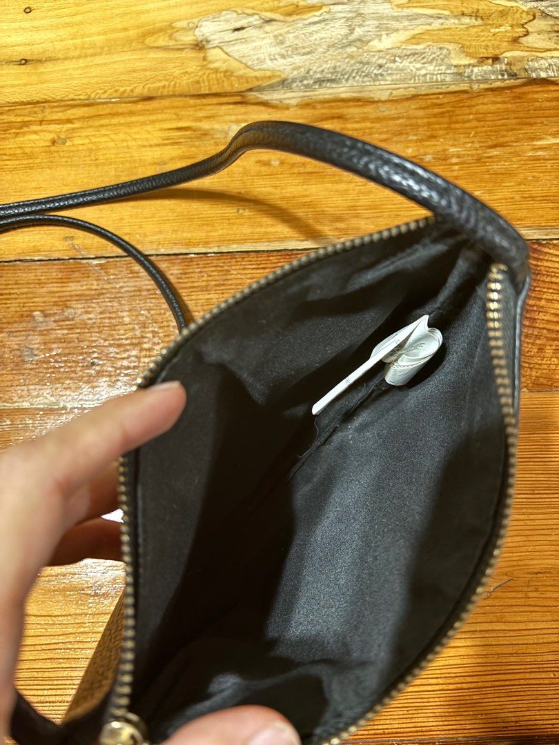 Small Black Crossbody Bag (Category: Cross-body Bags) located in Paranaque City. Submitted by cathsudon (Listing ID 1372670077, Image 3). Description: > Classic and goes with so many outfits > Long comfortable strap > Has super small marks on skin and zipper but not obvious > Rfs: Decluttering MOP: GCash Delivery: Grab or Lalamove Delivery fee will be shouldered by Buyer.