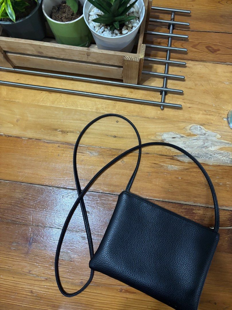 Small Black Crossbody Bag (Category: Cross-body Bags) located in Paranaque City. Submitted by cathsudon (Listing ID 1372670077, Image 2). Description: > Classic and goes with so many outfits > Long comfortable strap > Has super small marks on skin and zipper but not obvious > Rfs: Decluttering MOP: GCash Delivery: Grab or Lalamove Delivery fee will be shouldered by Buyer.