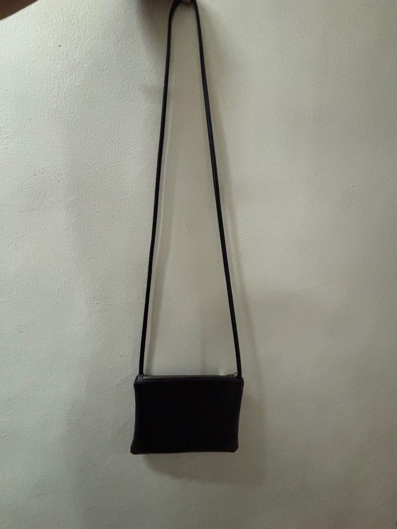 Small Black Crossbody Bag (Category: Cross-body Bags) located in Paranaque City. Submitted by cathsudon (Listing ID 1372670077, Image 1). Description: > Classic and goes with so many outfits > Long comfortable strap > Has super small marks on skin and zipper but not obvious > Rfs: Decluttering MOP: GCash Delivery: Grab or Lalamove Delivery fee will be shouldered by Buyer.