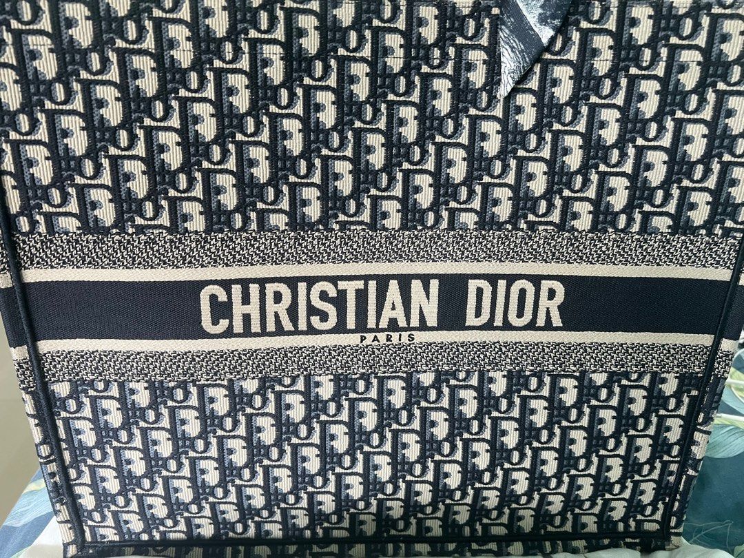 Christian Dior Book Tote Bag (Category: Bags & Wallets) located in Singapore. Submitted by miumeow7 (Listing ID 1377911789, Image 2). Description: Authentic Christian Dior Book Tote Bag. Features the iconic Dior Oblique pattern. Includes a scarf wrapped around the handles. In excellent condition, perfect for everyday use or special occasions. Condition 10/10 Comes with original receipt Brand new, unused and just stored in cupboard .