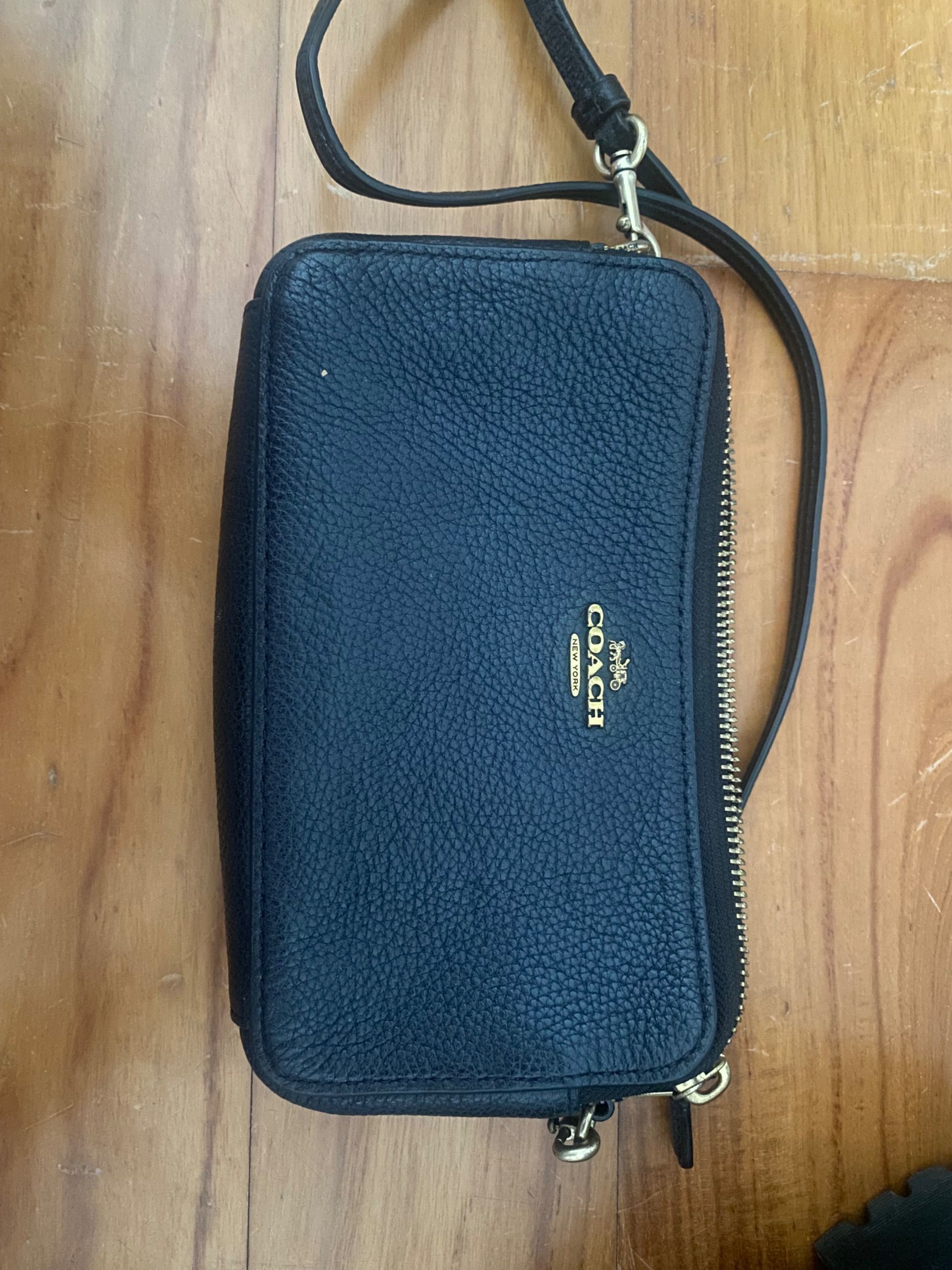 Coach Wristlet Wallet - Black (Category: Bags & Wallets) located in Singapore. Submitted by kuwonu (Listing ID 1377777092, Image 1). Description: Authentic Coach wristlet wallet in black. Features multiple compartments and a wrist strap. Includes original tags. Perfect for carrying essentials. In excellent condition..