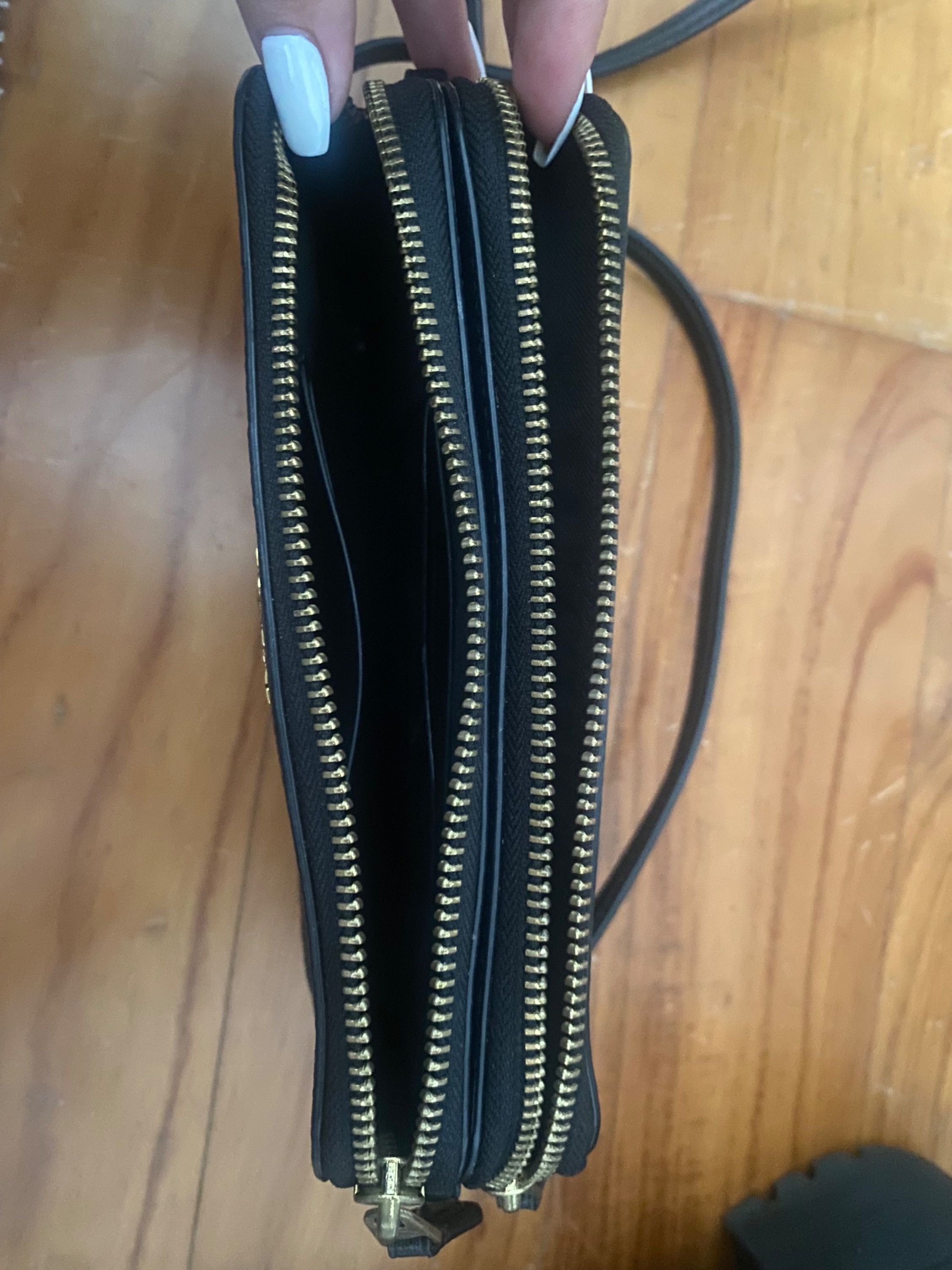 Coach Wristlet Wallet - Black (Category: Bags & Wallets) located in Singapore. Submitted by kuwonu (Listing ID 1377777092, Image 2). Description: Authentic Coach wristlet wallet in black. Features multiple compartments and a wrist strap. Includes original tags. Perfect for carrying essentials. In excellent condition..