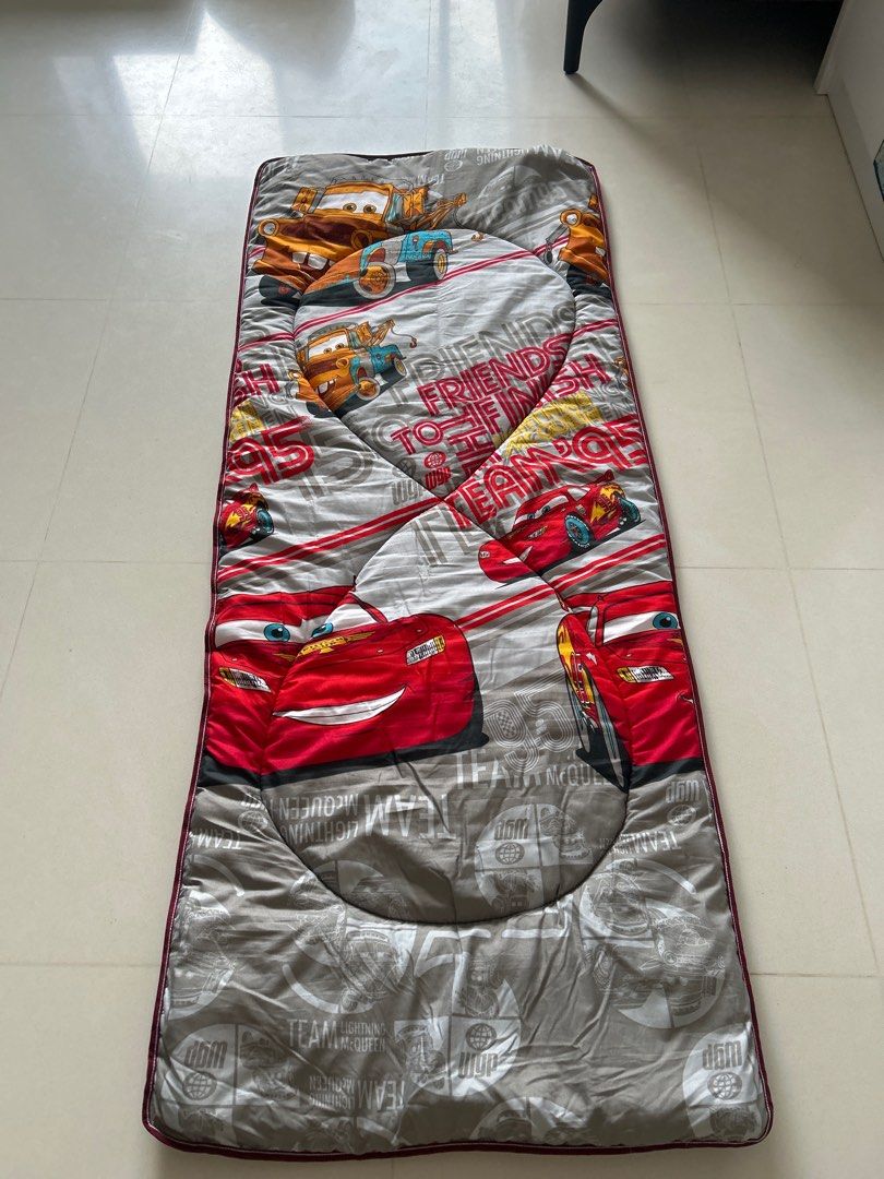 Disney Cars Sleeping Mat (Category: Childrens' Beds) located in Singapore. Submitted by theblingshop (Listing ID 1377762284, Image 3). Description: Cozy Disney Cars sleeping mat, perfect for sleepovers or camping. Features Lightning McQueen and Mater. In good condition, used for only once or twice. Easy to clean and store. Size is approximately 180cm x 73cm..