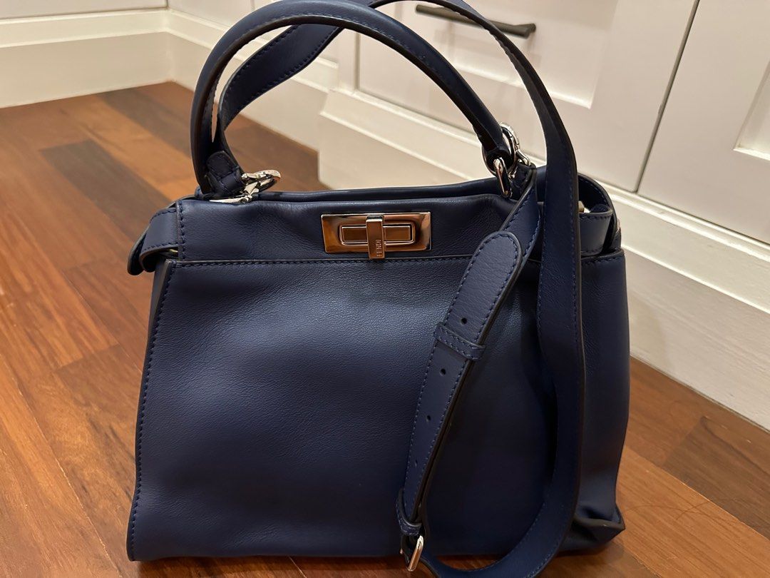 Fendi Peekaboo Handbag - Navy Blue (Category: Bags & Wallets) located in Singapore. Submitted by red_devil24 (Listing ID 1377944130, Image 2). Description: Authentic Fendi Peekaboo handbag in navy blue. Features a top handle and a detachable shoulder strap for versatile carrying options. The bag has a secure turn-lock closure and silver-tone hardware. In excellent condition, ready to be your next statement piece..