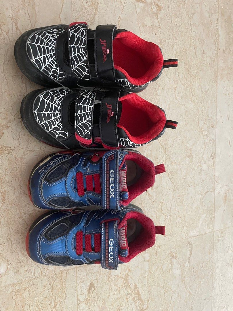 Geox & Spider-Man Light-Up Shoes - Size 26/9 (Category: Babies & Kids Fashion) located in Singapore. Submitted by elizang (Listing ID 1377790376, Image 1). Description: Two pairs of kids' shoes: Geox blue shoes and Spider-Man black shoes. Both pairs have velcro straps and light-up features. The Geox shoes are size 26/9. The Spider-Man shoes are size 26/10.5. Both are in good condition, with some signs of wear. Both are light up shoes still workin