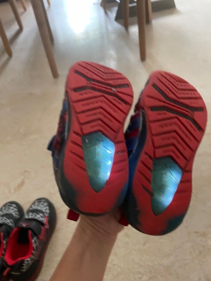 Geox & Spider-Man Light-Up Shoes - Size 26/9 (Category: Babies & Kids Fashion) located in Singapore. Submitted by elizang (Listing ID 1377790376, Image 2). Description: Two pairs of kids' shoes: Geox blue shoes and Spider-Man black shoes. Both pairs have velcro straps and light-up features. The Geox shoes are size 26/9. The Spider-Man shoes are size 26/10.5. Both are in good condition, with some signs of wear. Both are light up shoes still workin
