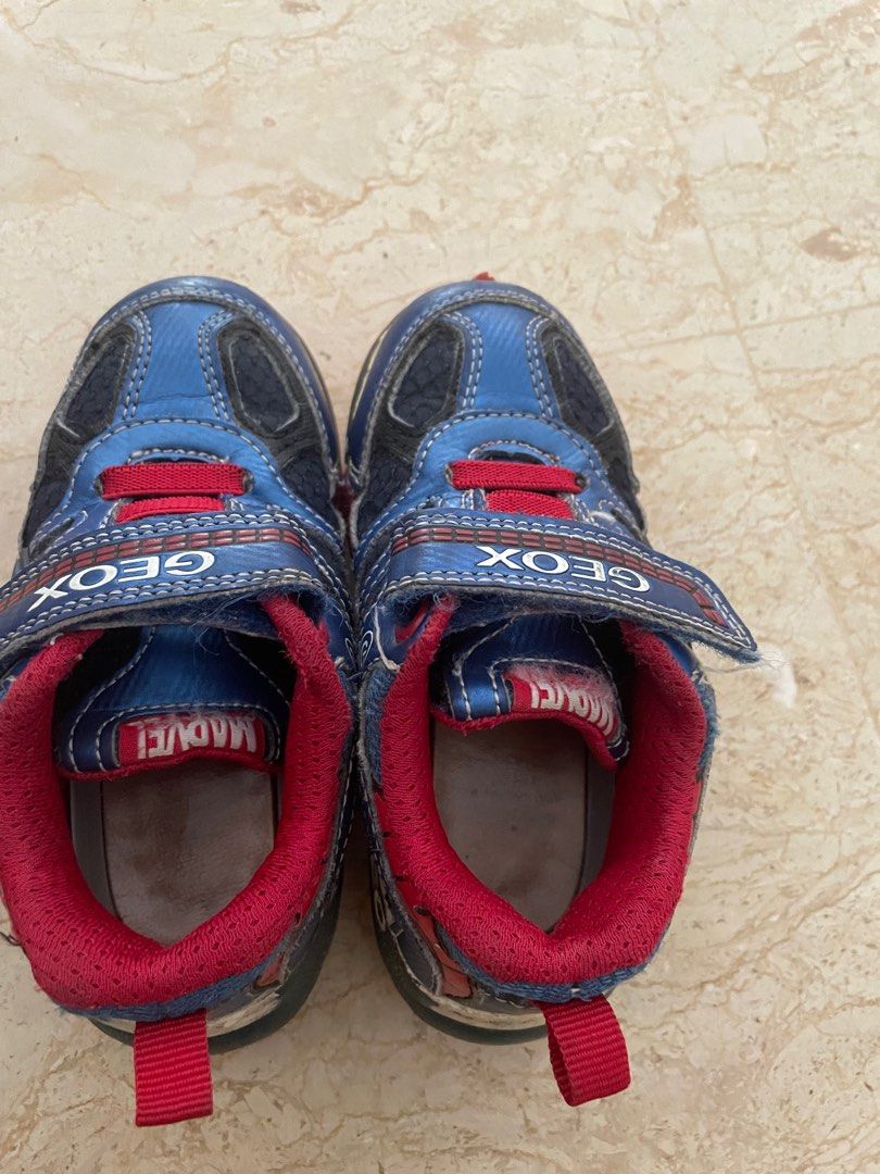Geox & Spider-Man Light-Up Shoes - Size 26/9 (Category: Babies & Kids Fashion) located in Singapore. Submitted by elizang (Listing ID 1377790376, Image 3). Description: Two pairs of kids' shoes: Geox blue shoes and Spider-Man black shoes. Both pairs have velcro straps and light-up features. The Geox shoes are size 26/9. The Spider-Man shoes are size 26/10.5. Both are in good condition, with some signs of wear. Both are light up shoes still workin