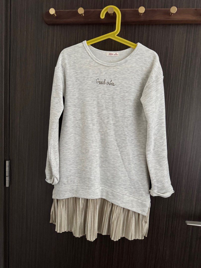 Grey Sweater Dress with Pleated Skirt (Category: Babies & Kids Fashion) located in Singapore. Submitted by bibi0122 (Listing ID 1377758669, Image 1). Description: Stylish grey sweater dress with a pleated skirt detail. Features 'Good Vibes' embroidery. Perfect for a casual yet chic look. Comfortable and easy to wear. Great for layering..