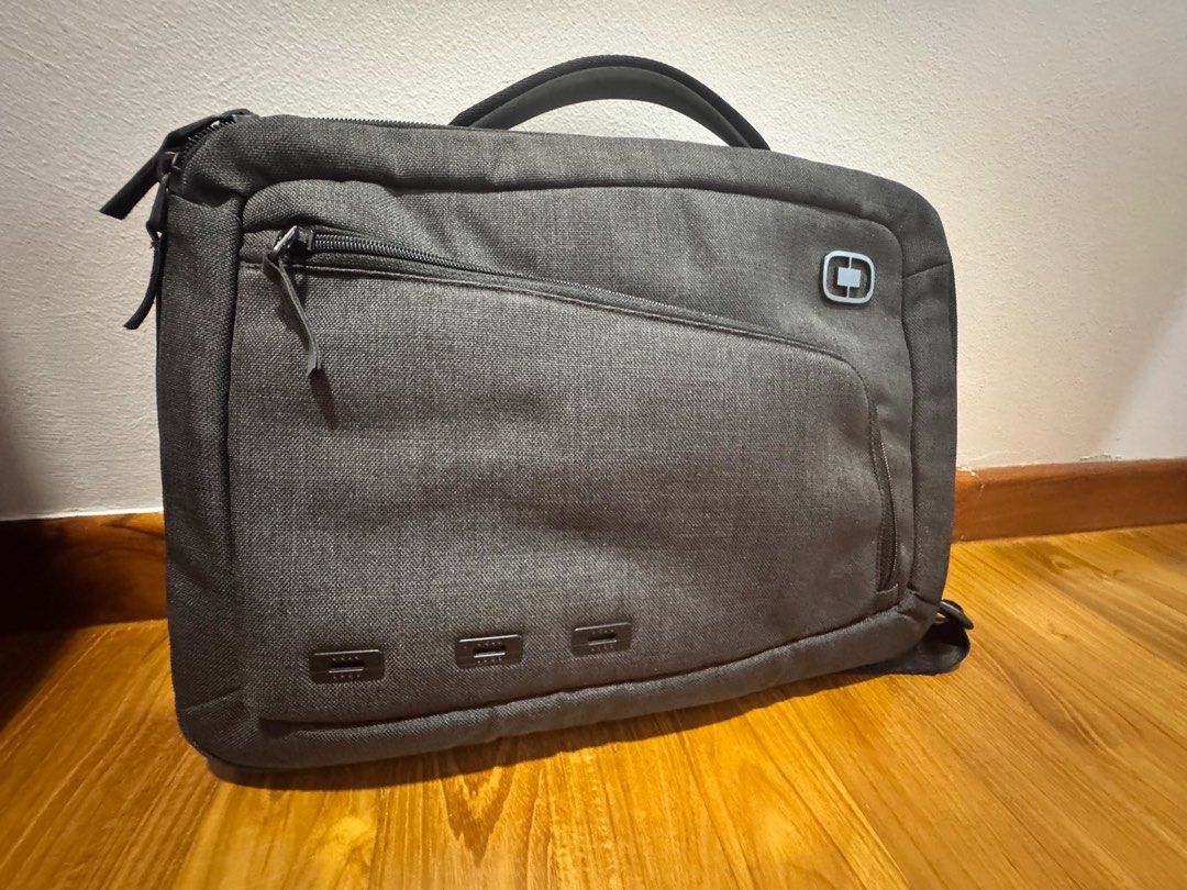 OGIO Laptop Briefcase - Grey (Category: Briefcases) located in Singapore. Submitted by the.restless (Listing ID 1377768477, Image 2). Description: This OGIO laptop briefcase is in great condition. It features multiple compartments for storage, including a front pocket and a main compartment. It has a handle and a shoulder strap for carrying. The bag is made of a durable material and is perfect for work or travel..