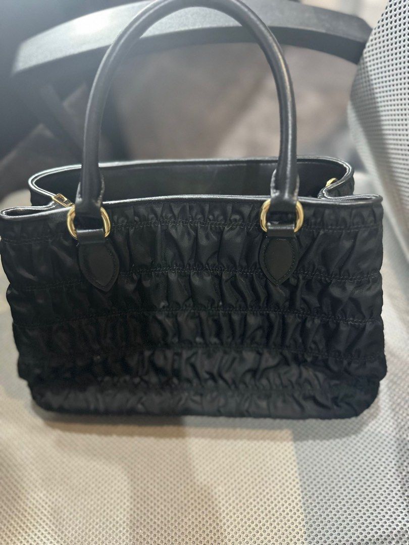 PRADA TESSUTO GAUFRE TOTE BAG (Category: Bags & Wallets) located in Singapore. Submitted by kasub (Listing ID 1377755167, Image 2). Description: Elegant Prada shopping bag in black leather. Features a zip closure, two handles, and a removable shoulder strap. Includes an internal pocket and a dustbag. Dimensions are 11.5" x 7.5" x 5.5". Aunthencity card and dust bag included..