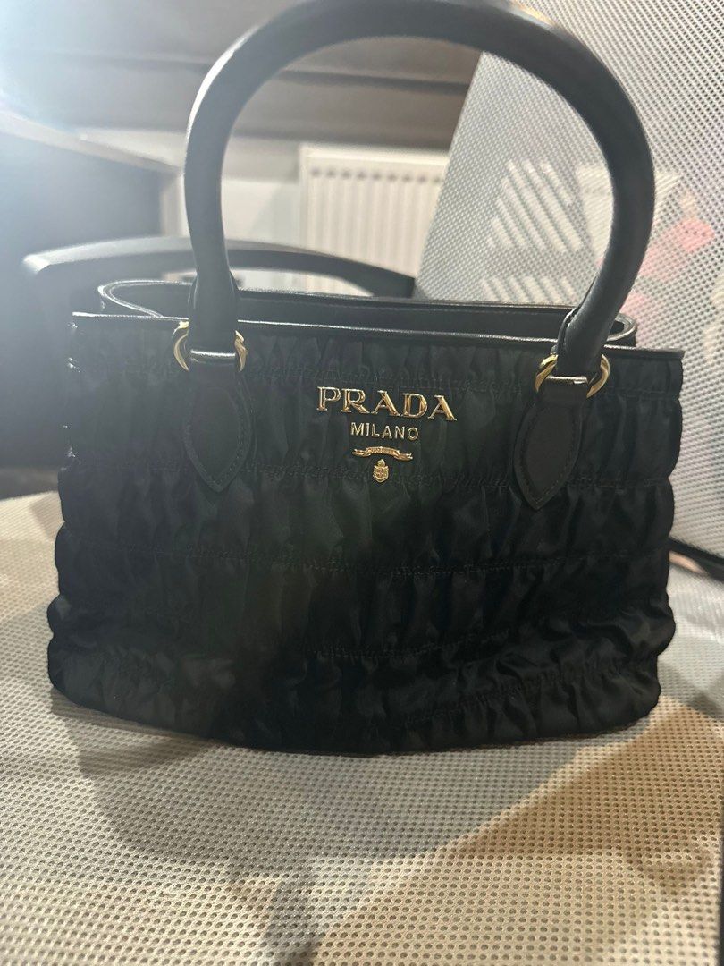 PRADA TESSUTO GAUFRE TOTE BAG (Category: Bags & Wallets) located in Singapore. Submitted by kasub (Listing ID 1377755167, Image 1). Description: Elegant Prada shopping bag in black leather. Features a zip closure, two handles, and a removable shoulder strap. Includes an internal pocket and a dustbag. Dimensions are 11.5" x 7.5" x 5.5". Aunthencity card and dust bag included..